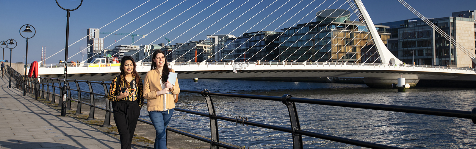 NCI CIPD students walking beside Samuel Beckett Bridge in Dublin City Centre