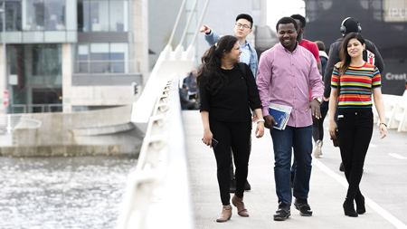 Students walking across the Samuel Beckett Bridge in Dublin