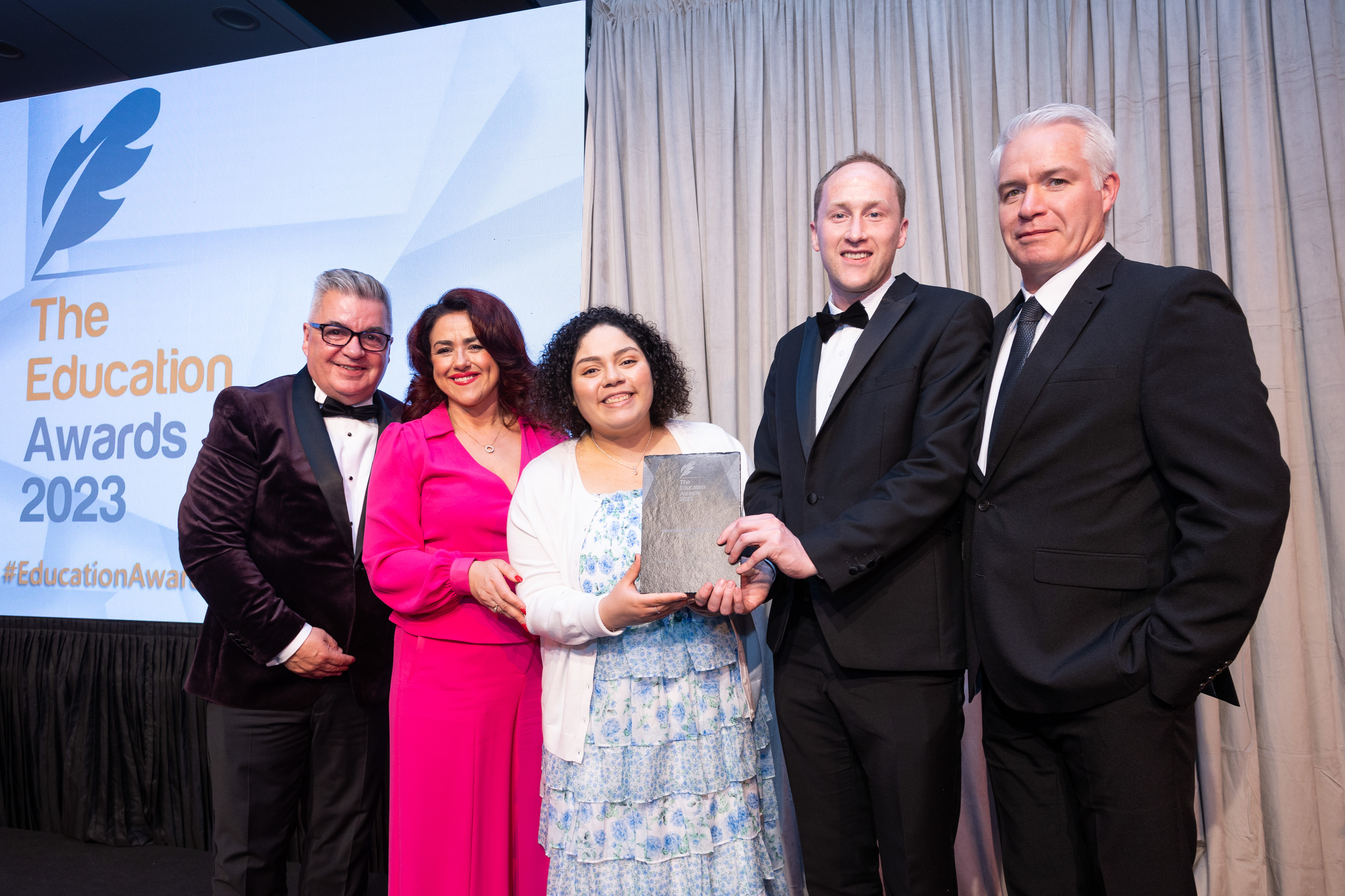 NCI's Brenda de Azevedo, Michael Shiel, Professor Jimmy Hill and Robert Ward accepting Best International Engagement at Education Awards 2023