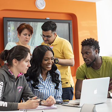 Group of MA in HRM students working on a computer in NCI