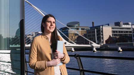NCI student standing beside the River Liffey in Dublin