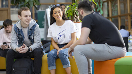 NCI students sitting in Atrium in NCI campus building