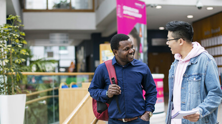 Students talking at NCI front entrance