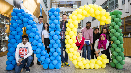 International students with ballon shapre letters NCI