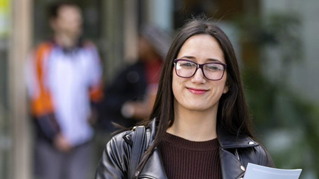 NCI business student smiling at camera