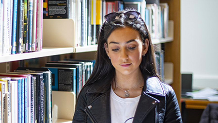 NCI student reading in library