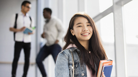 NCI International student standing on staircase 