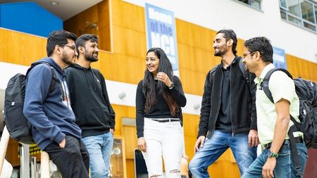 Students laughing at reception area on NCI campus