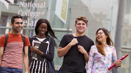 Four students standing outside NCI entrance