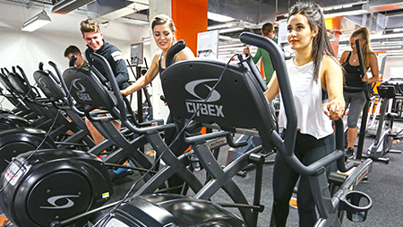 Students on exercise machines in the gym