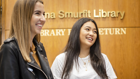 Two students standing outside NCI library