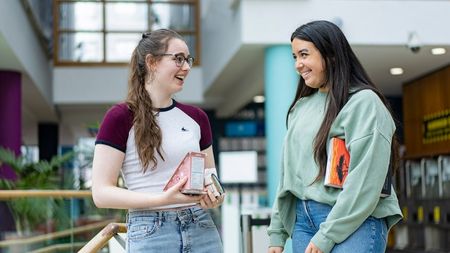 Two NCI students talking to each other