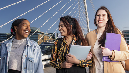 NCI finance students walking across the Samuel Beckett bridge in Dublin