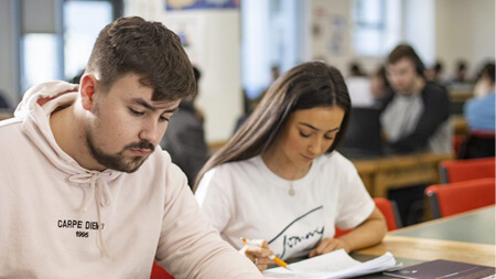 Students reading textbooks in NCI classroom