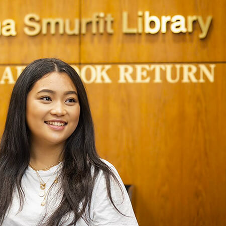 NCI student standing outside library