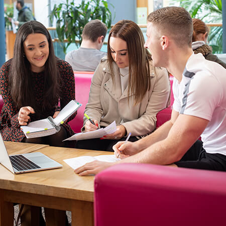 Three Springboard+ students working on an assignment in NCI