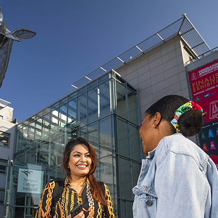 International students standing outside NCI campus building