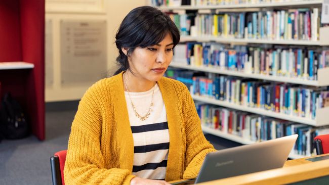 NCI psychology student working in NCI library