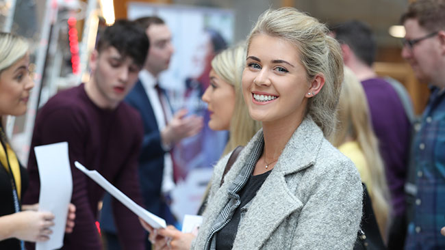 NCI student smiling at camera during a Careers Fair