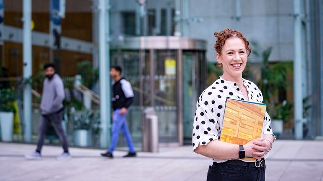 NCI student holding NCI prospectus 