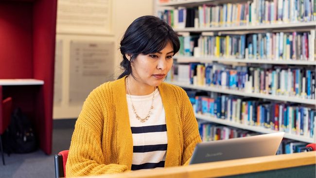 NCI student working on laptop in NCI library