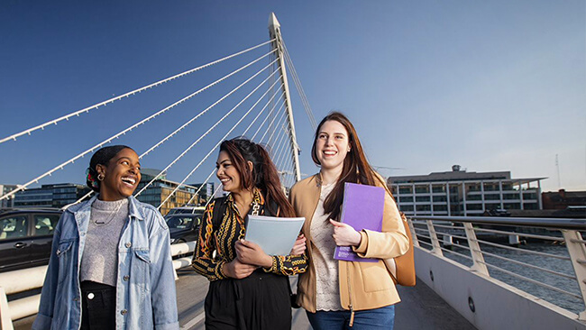 NCI students walking across the Samuel Beckett bridge in Dublin