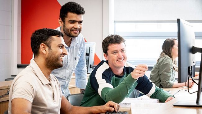 NCI students working on a computer