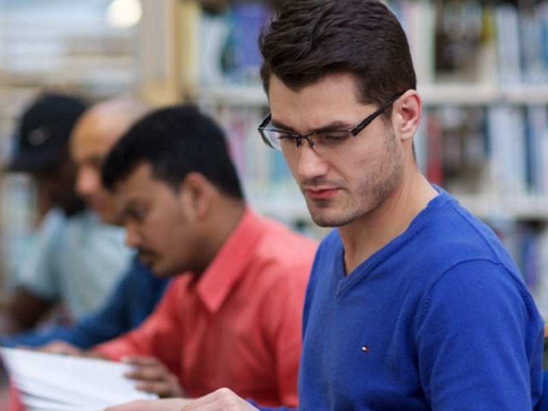 NCI MBA student studying in library