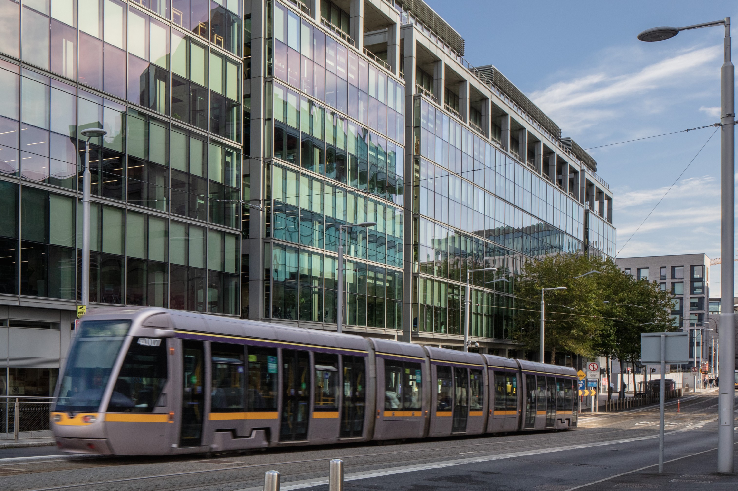 A Luas crosses in front of NCI Spencer Dock