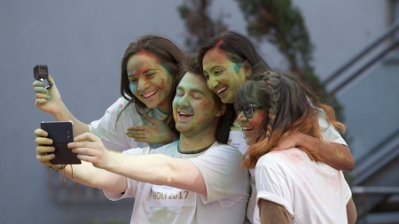 Image of International Students taking Selfie during Holi Event
