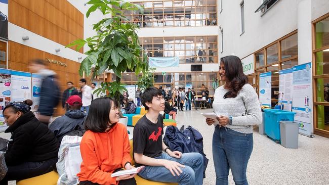 International students chating with International peer mentor at NCI atrium