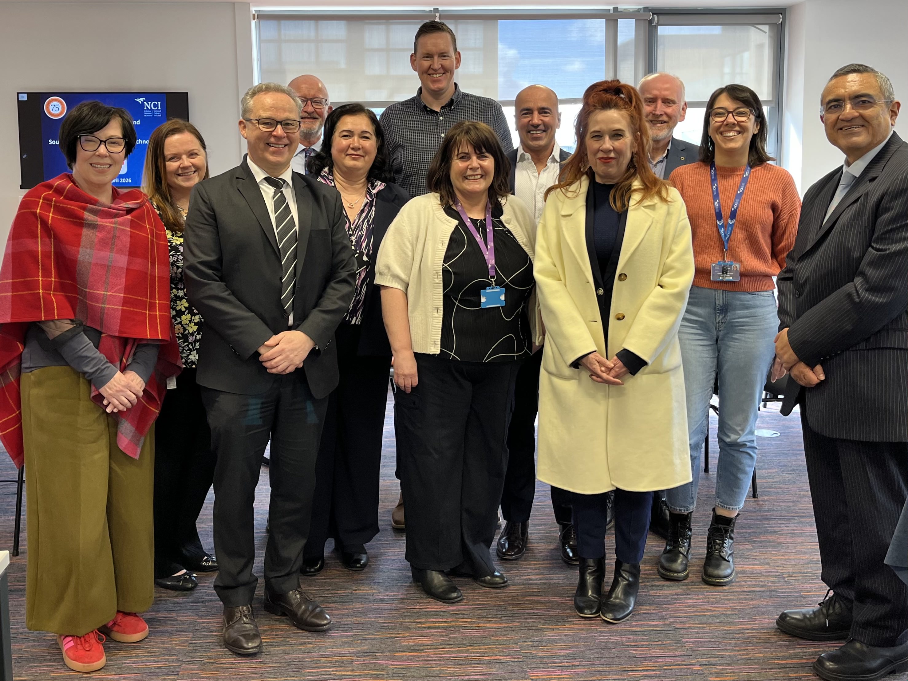 Staff from SAIT and NCI celebrate the signing of a partnership between the two colleges