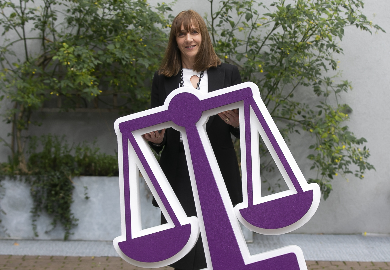 Professor Gina Quin, President NCI, with a scales prop to promote equality.