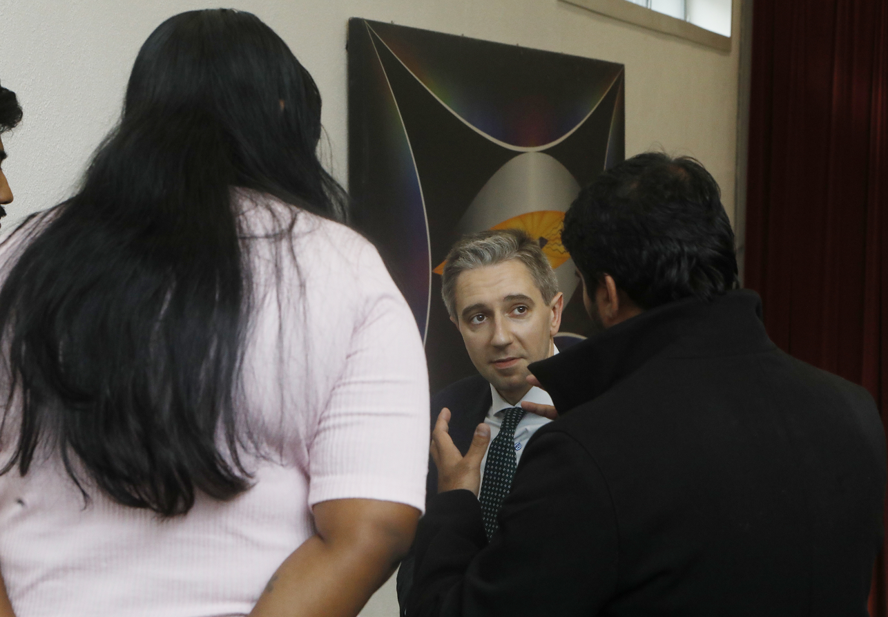 Minister Simon Harris DFHERIS surrounded by NCI students