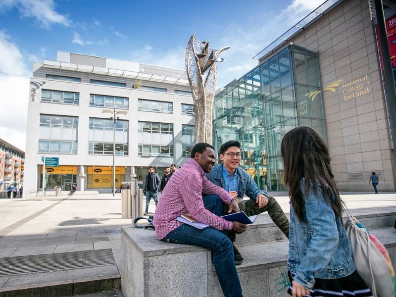 Students sitting outside NCI campus