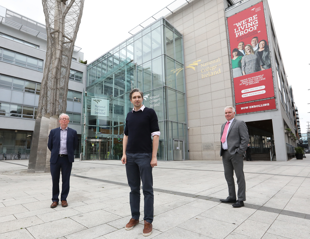 NCI Registrat John McGarrigle, Minister Simon Harris DFHERIS and Director of Marketing Robert Ward stand outside the NCI campus