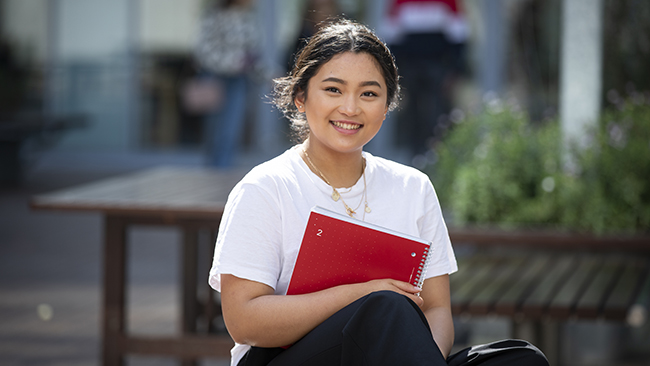 Female student holding notebook